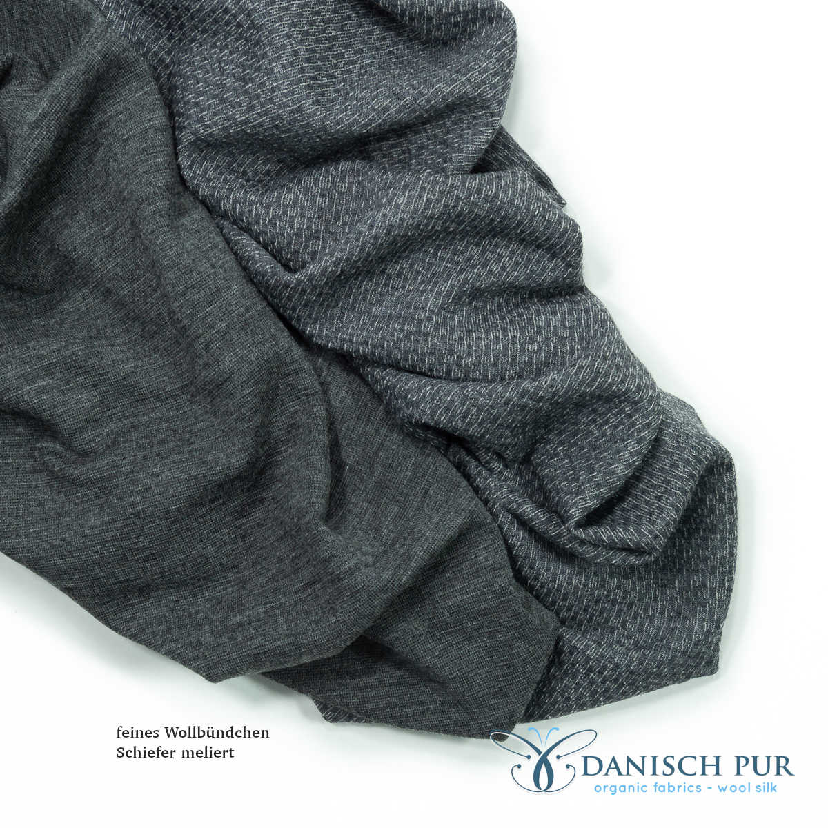 Fine organic wool cuffs mottled slate (kbt, mulesing-free) in a tube