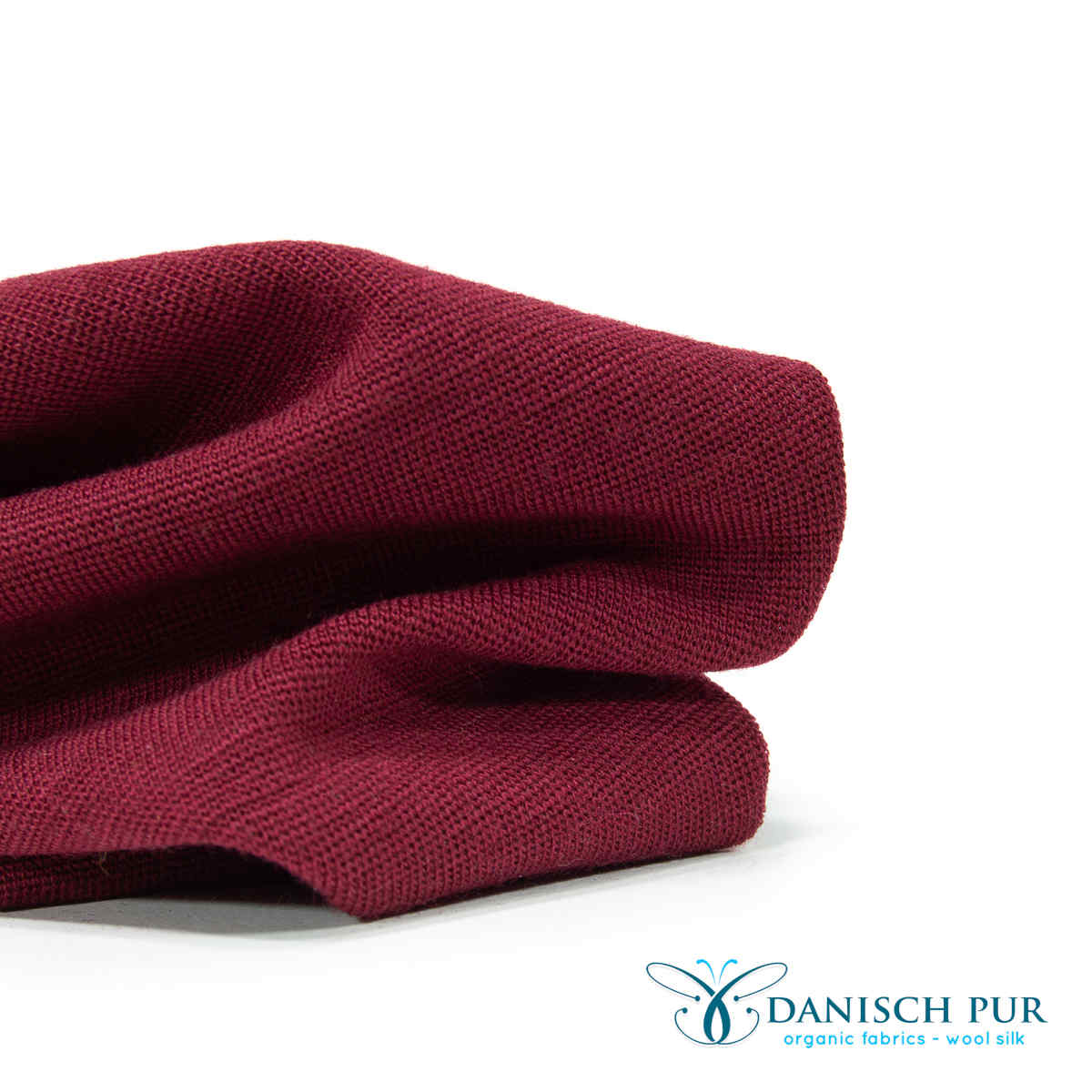 Fine organic wool cuffs light crimson (organic, mulesing-free) in a tube