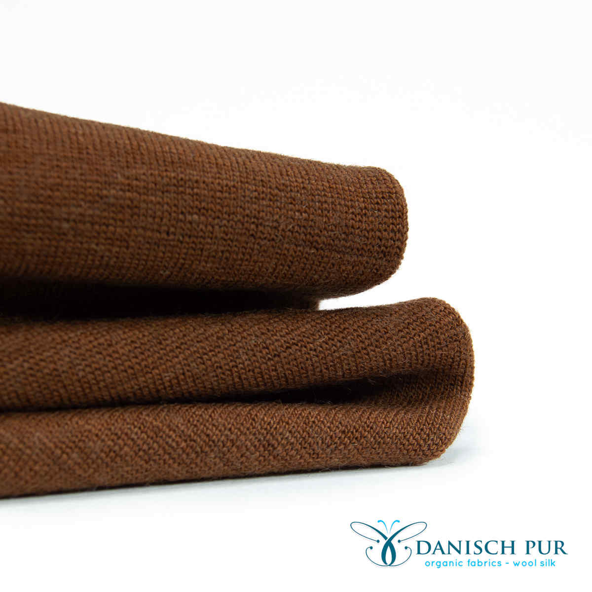 Fine organic wool cuffs light cinnamon (kbt, mulesing-free) in a tube